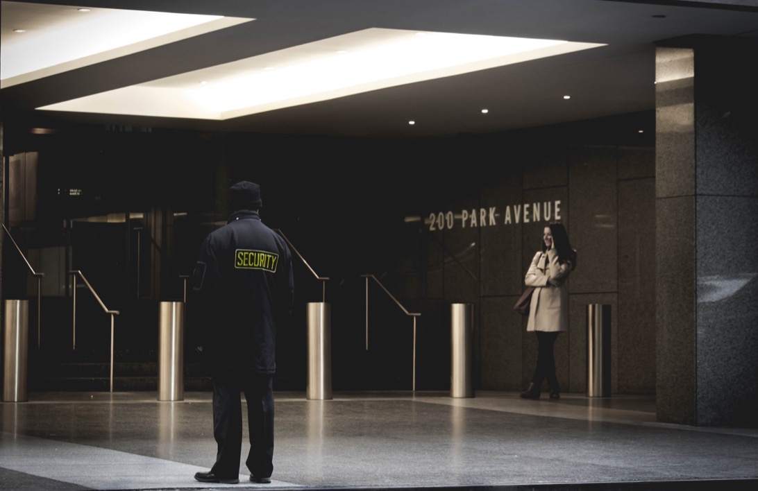 Professional security guard stationed in an business lobby.